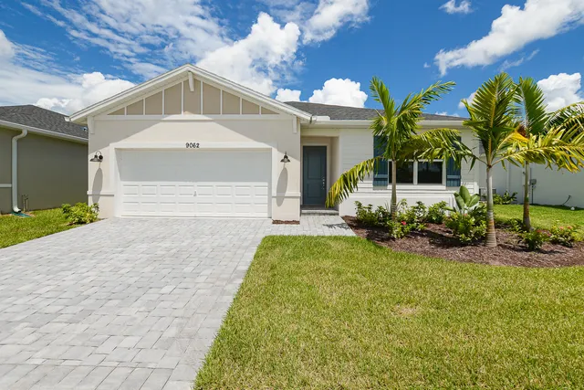 a front view of house with yard and outdoor seating