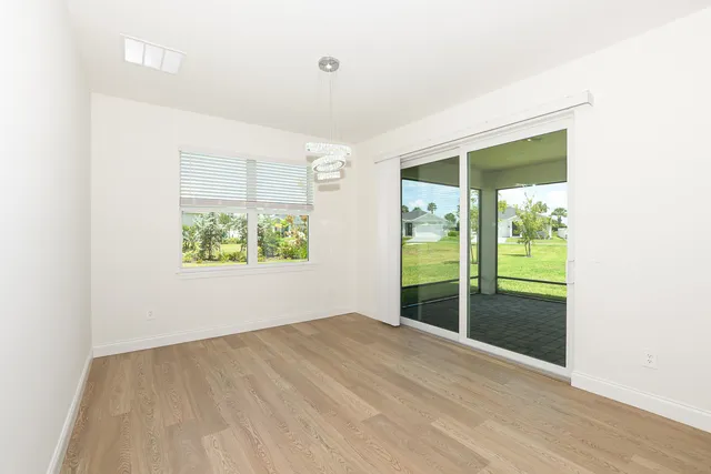 a kitchen with granite countertop white cabinets and stainless steel appliances