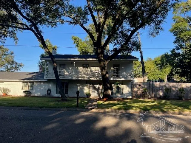 a view of a house with a yard and garage