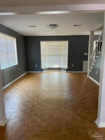 a bedroom with a bed and flat tv screen on the dresser