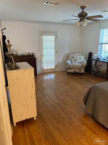 a vase of flowers sitting on a floor