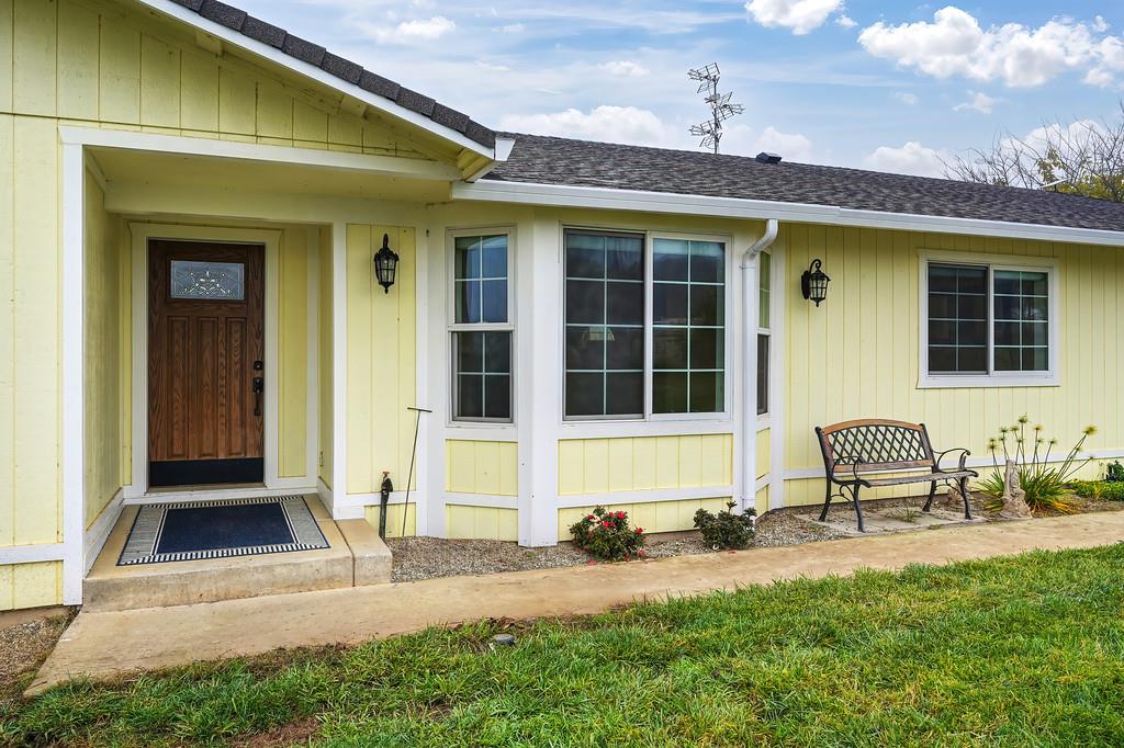 12156 Scott Grant Road Marysville, CA 95901 - Photo 24 of 77 a front view of a house with outdoor seating and a potted plant