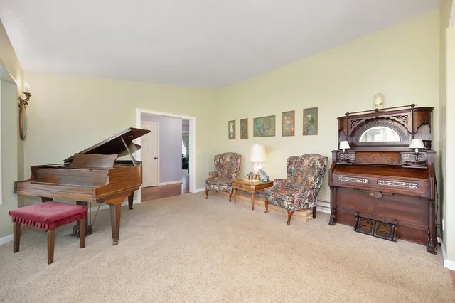 a bedroom with furniture and a flat screen tv