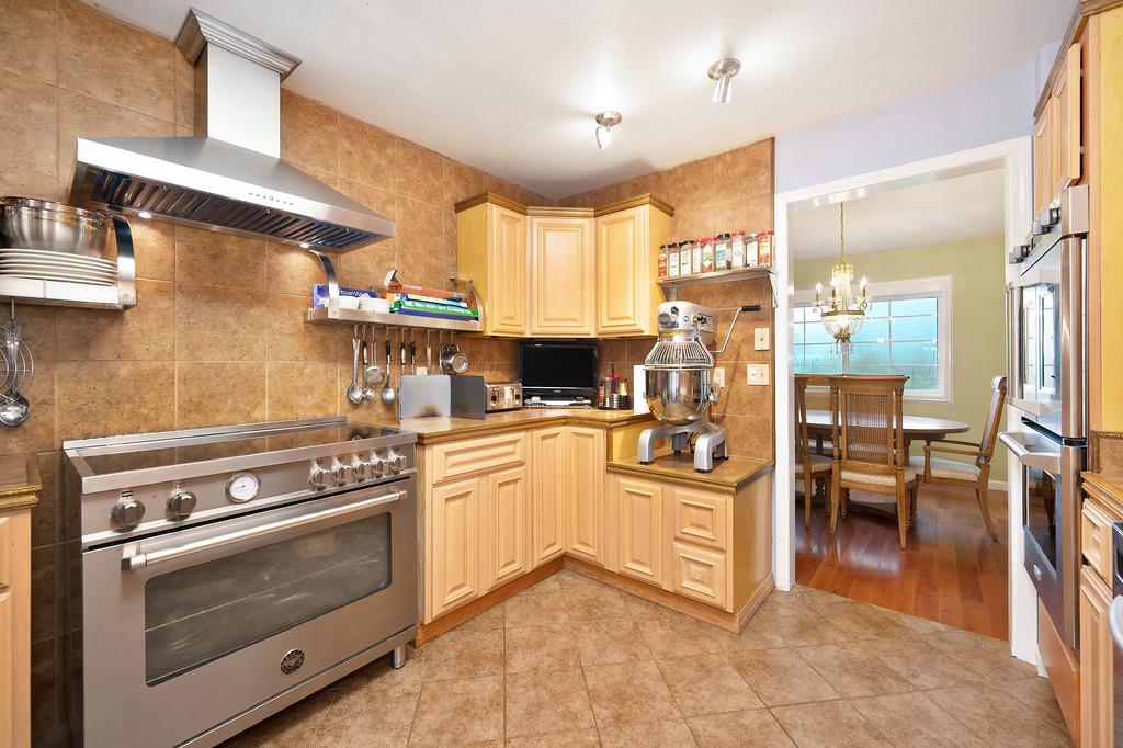 12156 Scott Grant Road Marysville, CA 95901 - Photo 30 of 77 a kitchen with stainless steel appliances granite countertop a stove and a refrigerator