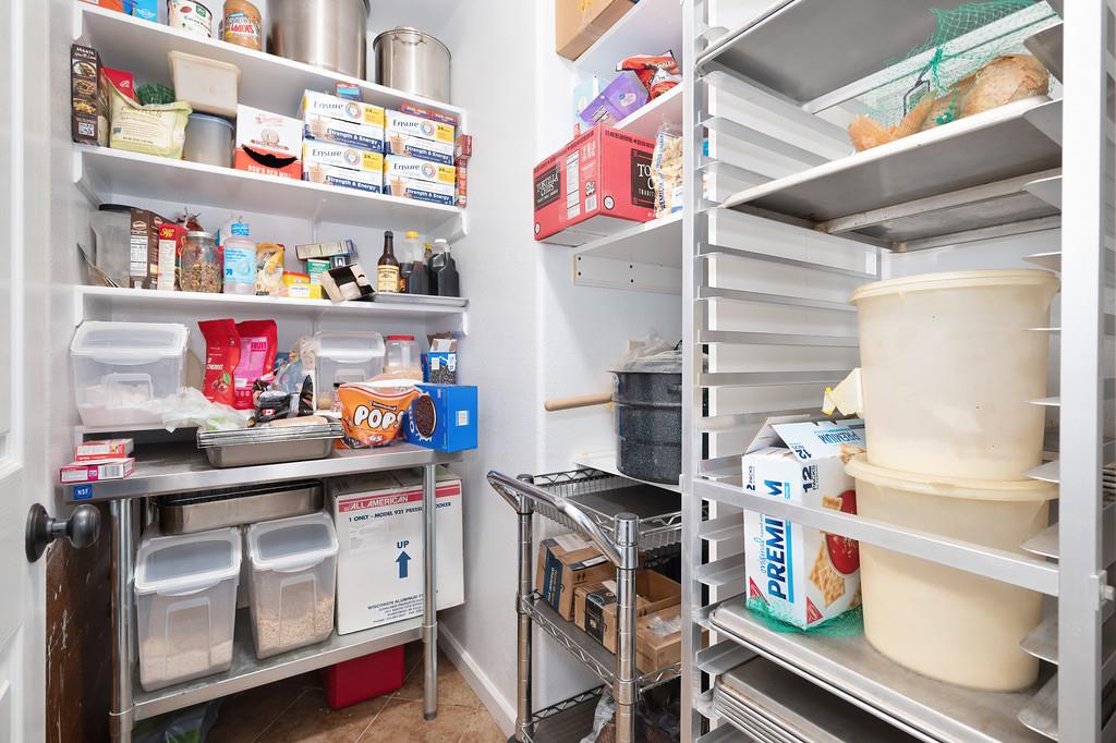 12156 Scott Grant Road Marysville, CA 95901 - Photo 37 of 77 a utility room with lots of clutter and cabinets