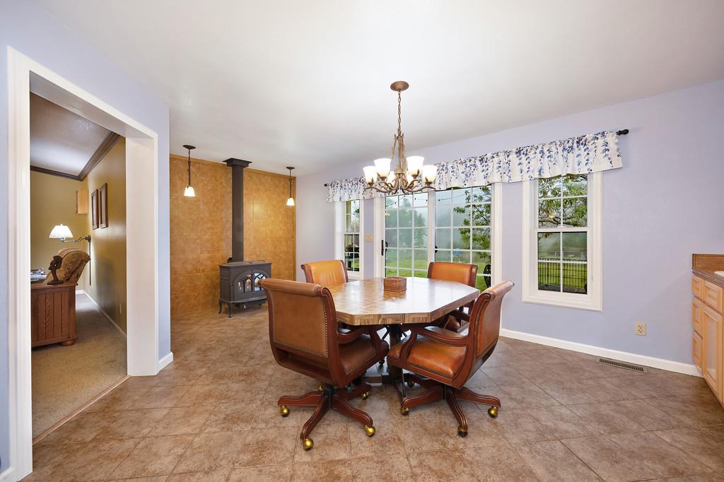 12156 Scott Grant Road Marysville, CA 95901 - Photo 8 of 77 a dining room with furniture a chandelier and wooden floor