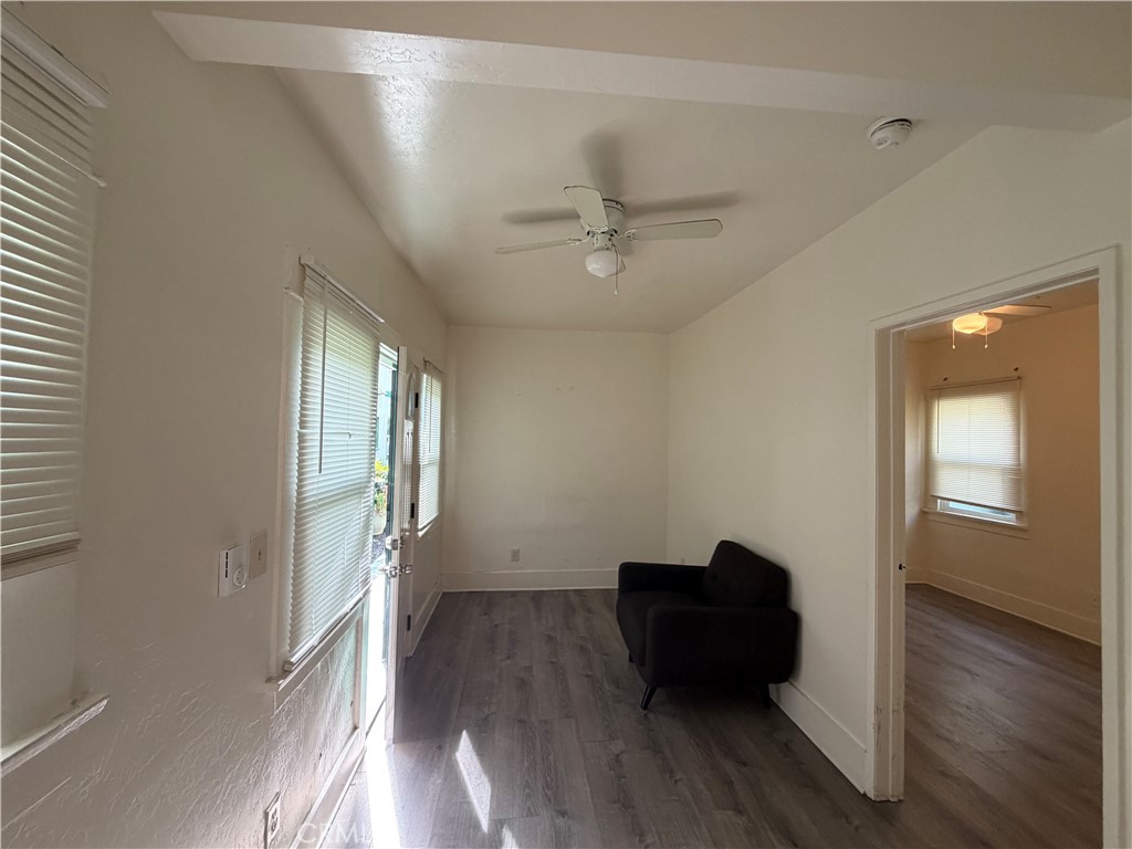 1917 East 4th Street, Unit 9 Long Beach, CA 90802 - Photo 8 of 14 an empty room with wooden floor a ceiling fan and windows