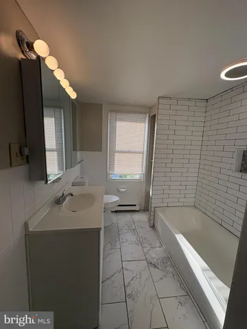 a bathroom with a bathtub and a sink