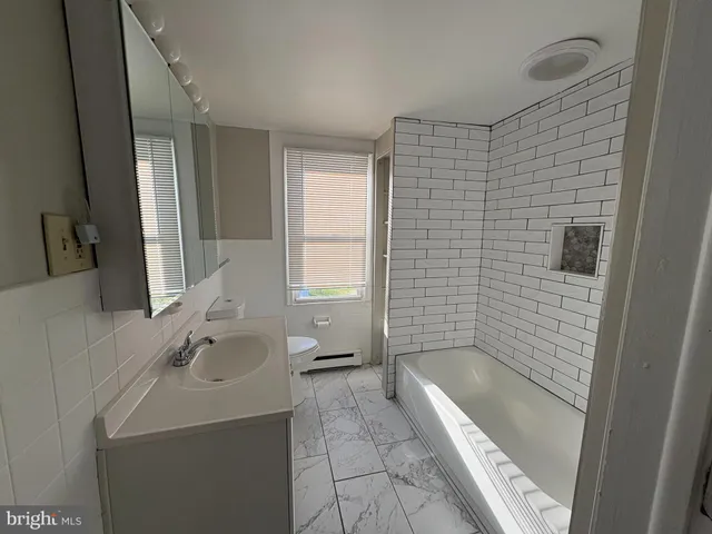 a bathroom with a sink a bathtub and a shower