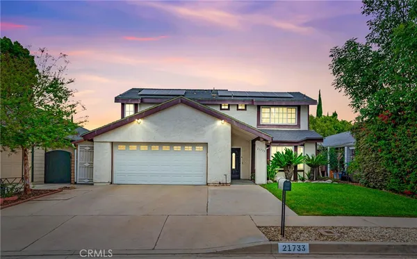 a view of a house with a yard and garage