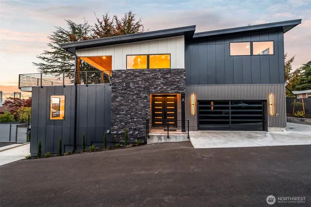 a front view of a house with yard and garage