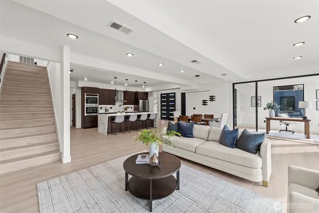 a view of a patio with table and chairs under an umbrella with wooden floor