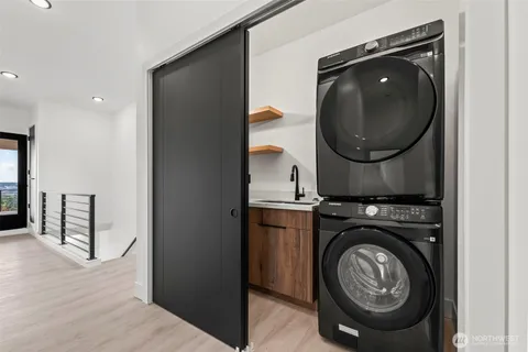 a large bed sitting in a bedroom next to a window