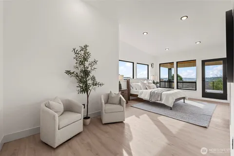 a bedroom with a large bed and a large window