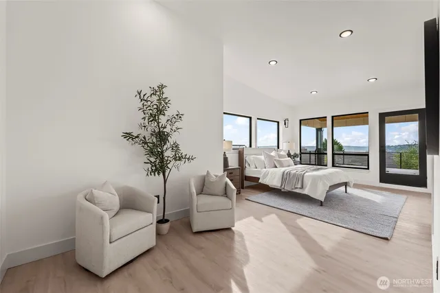 a bedroom with a large bed and a large window