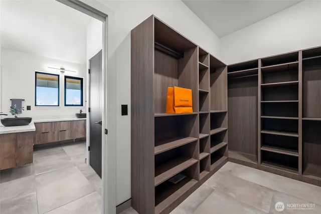 a bathroom with a sink a toilet a mirror and bathtub