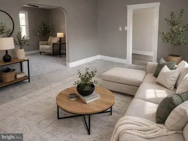 a living room with furniture and a potted plant