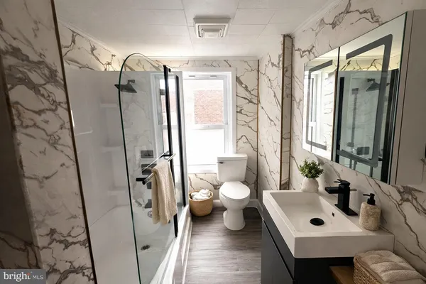 a bathroom with a sink toilet and shower