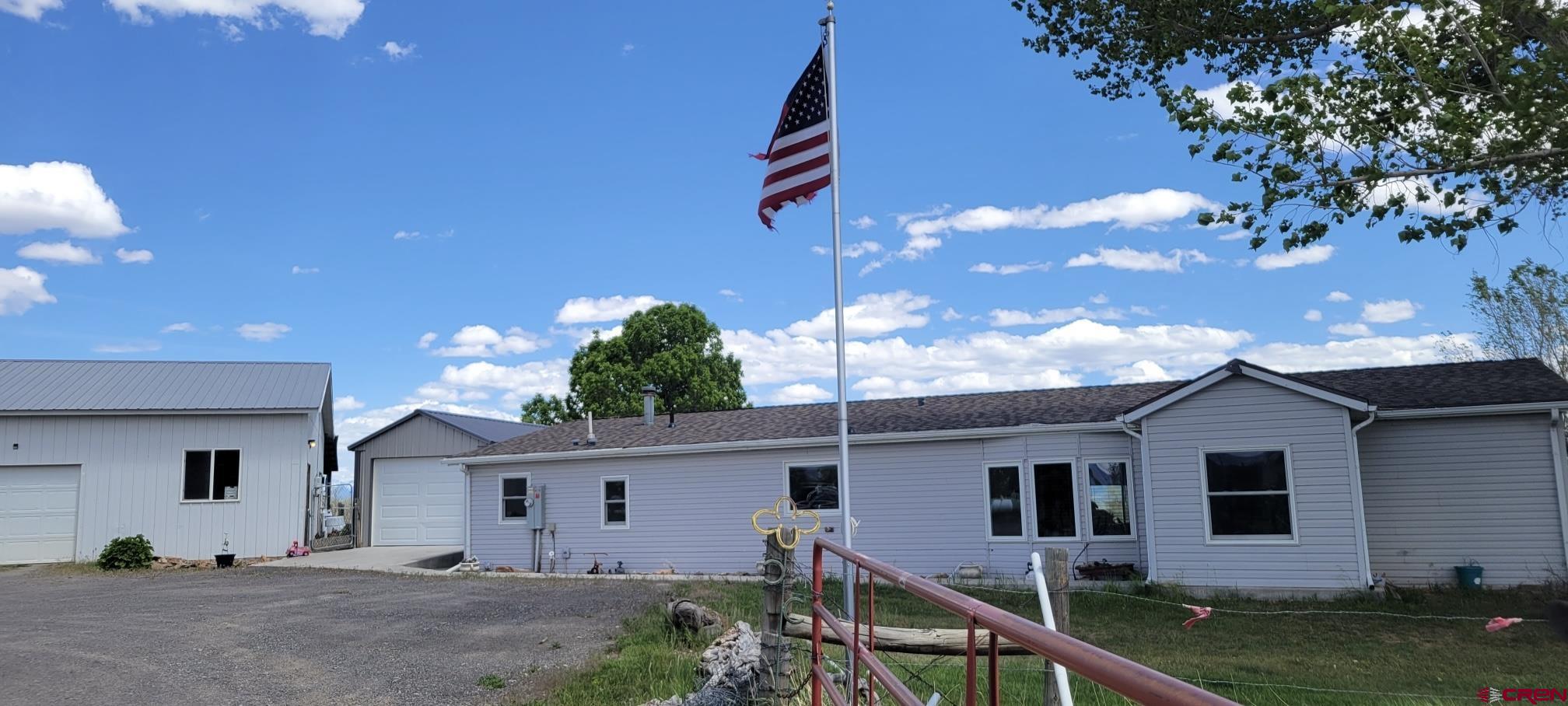 12880 2900th Road Hotchkiss, CO 81419 - Photo 2 of 22 a front view of a house with garden