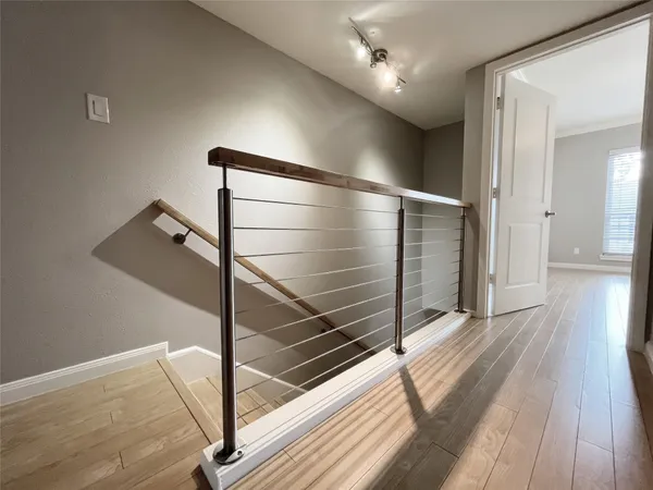 a view of a hallway with wooden floor