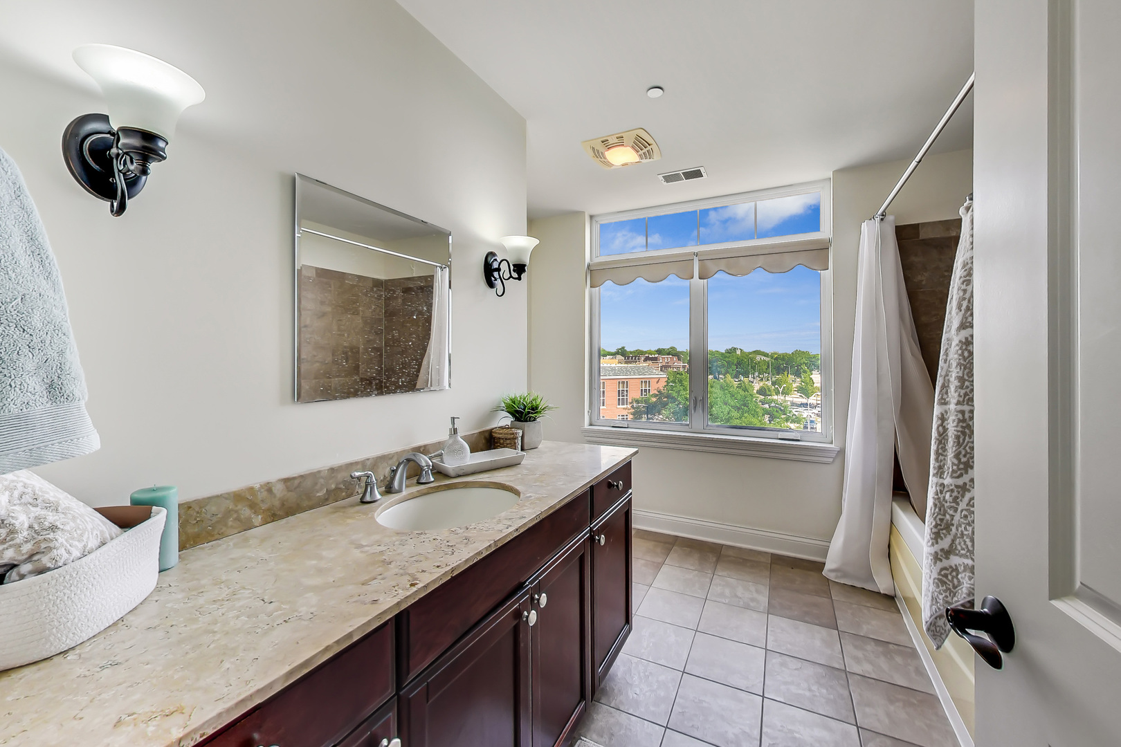 600 West Touhy Avenue, Unit 303 Park Ridge, IL 60068 - Photo 22 of 32 a bathroom with a granite countertop sink and a mirror