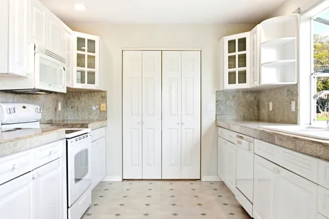 a bedroom with a bed and a ceiling fan
