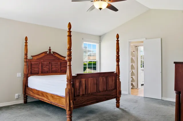 a bed sitting in a room next to a window