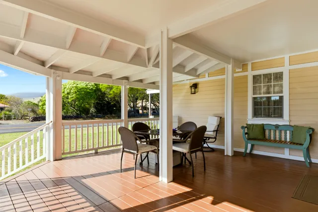a living room with furniture and floor to ceiling windows