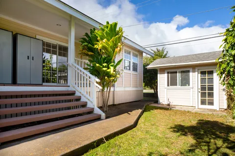 a view of a house with backyard and porch