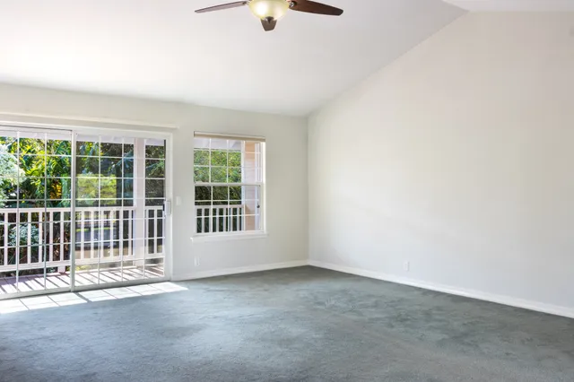 an empty room with windows and entrance