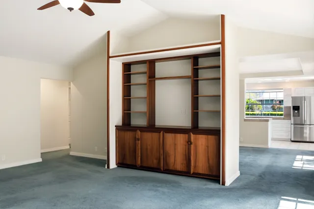 a view of a chandelier fan in big room