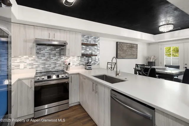 a kitchen with stainless steel appliances a stove sink and cabinets