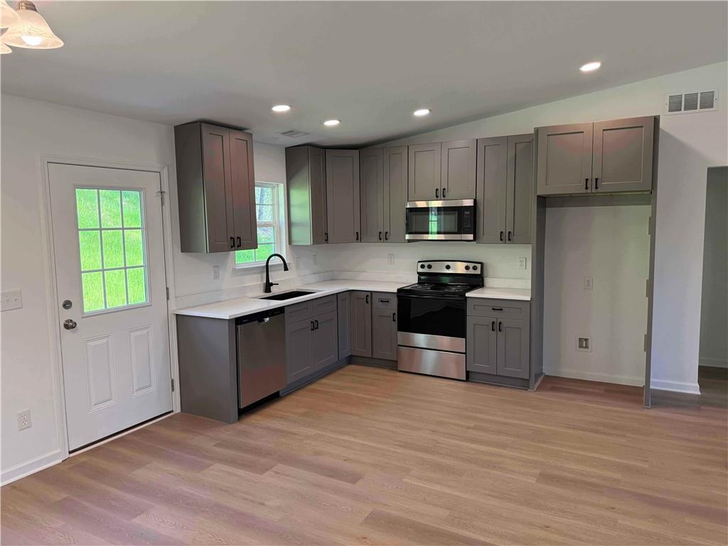 81 Loper Lane Ellijay, GA 30540 - Photo 11 of 29 a kitchen with kitchen island granite countertop a sink cabinets and stainless steel appliances
