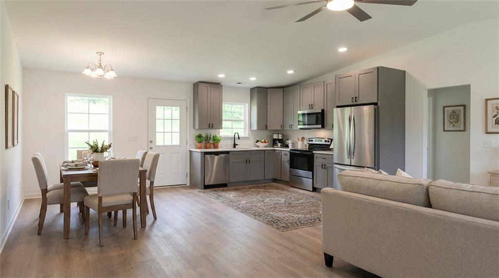 81 Loper Lane Ellijay, GA 30540 - Photo 12 of 29 a living room with furniture wooden floor and a kitchen view