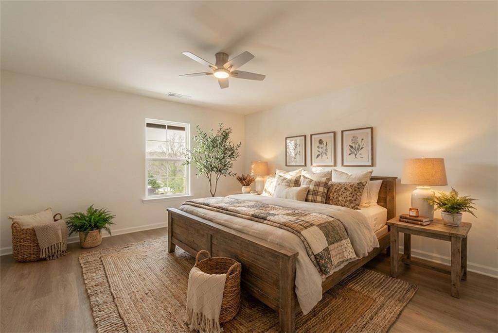 81 Loper Lane Ellijay, GA 30540 - Photo 16 of 29 a bedroom with a bed and a potted plant