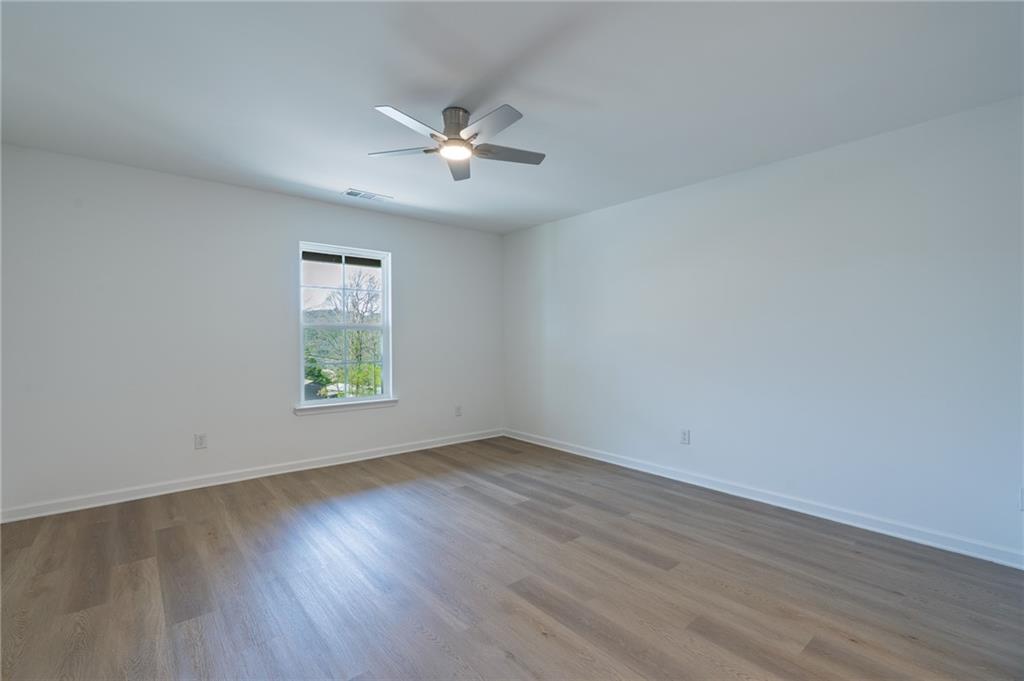 81 Loper Lane Ellijay, GA 30540 - Photo 17 of 29 a view of an empty room with wooden floor and a window