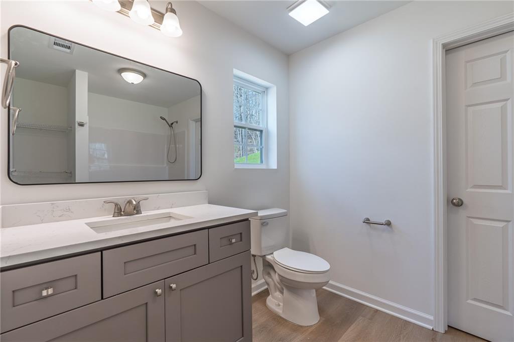 81 Loper Lane Ellijay, GA 30540 - Photo 21 of 29 a bathroom with a toilet sink and mirror