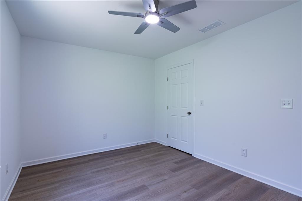 81 Loper Lane Ellijay, GA 30540 - Photo 25 of 29 a view of an empty room with wooden floor and a ceiling fan