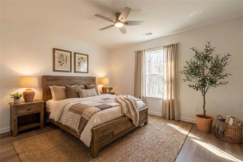 81 Loper Lane Ellijay, GA 30540 - Photo 27 of 29 a bed room with a bed and a potted plant