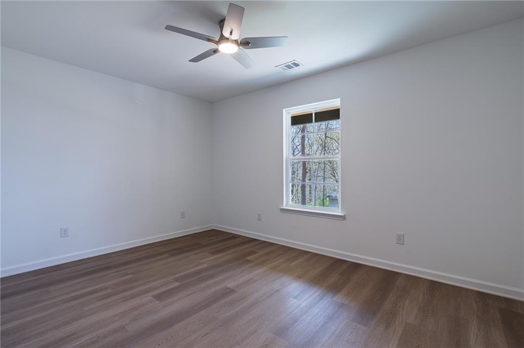81 Loper Lane Ellijay, GA 30540 - Photo 28 of 29 a view of empty room with wooden floor and fan
