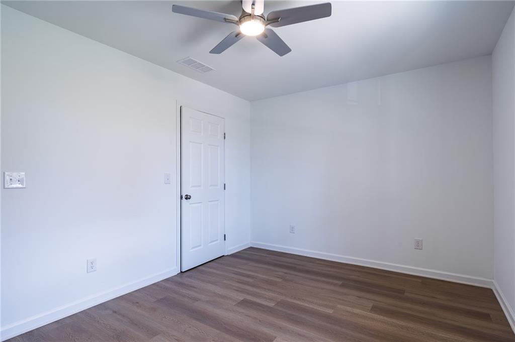 81 Loper Lane Ellijay, GA 30540 - Photo 29 of 29 a view of an empty room with wooden floor and a ceiling fan