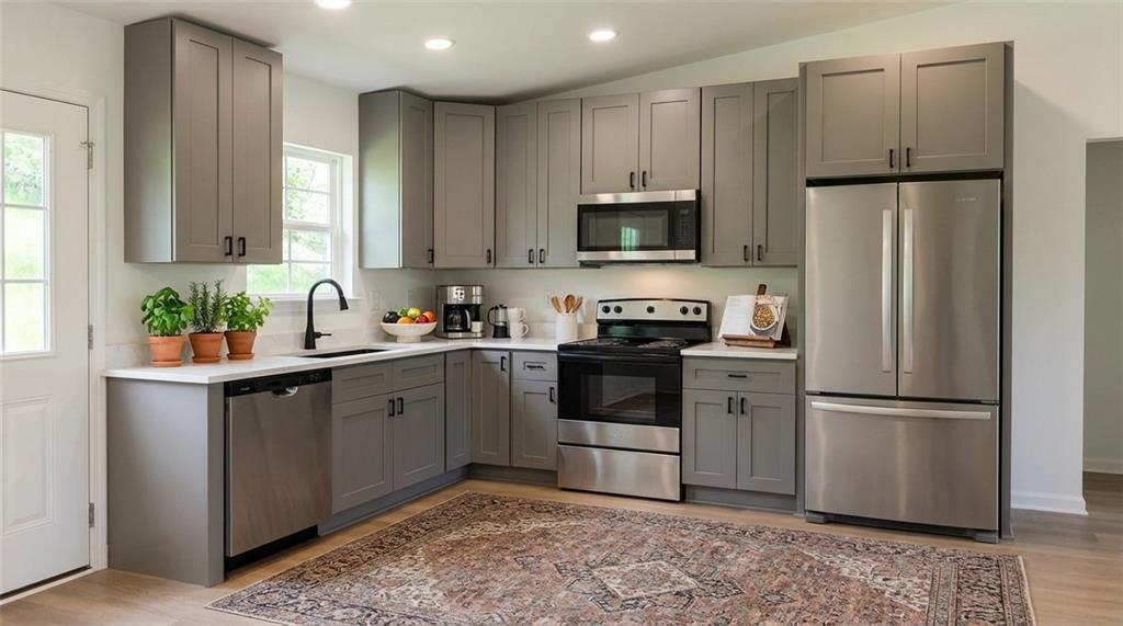 81 Loper Lane Ellijay, GA 30540 - Photo 10 of 29 a kitchen with white cabinets and stainless steel appliances