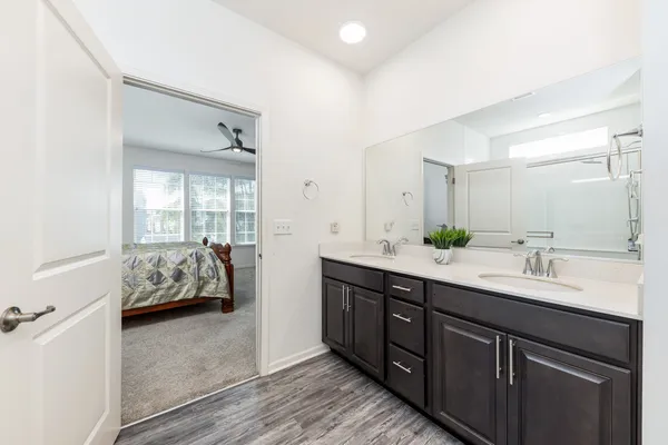a spacious bathroom with a double vanity sink and mirror