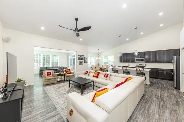 a living room with furniture and a wooden floor