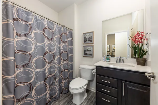 a bathroom with a sink and mirror with toilet