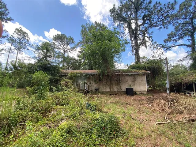 a backyard of a house with table and chairs