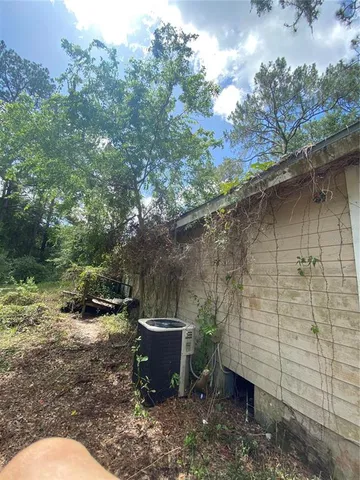 a backyard of a house with table and chairs