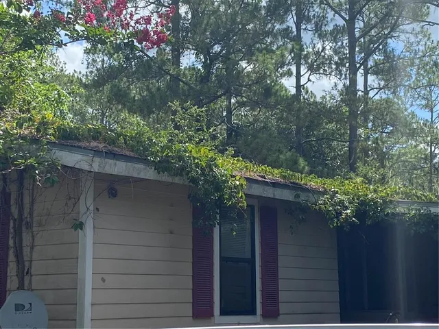 a view of a house with a tree