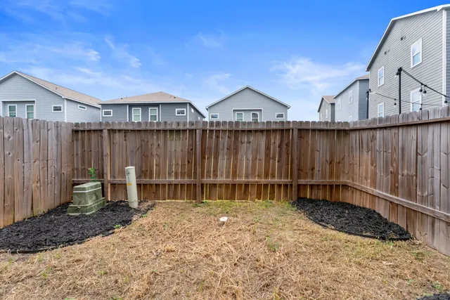 a backyard of a house with table and chairs