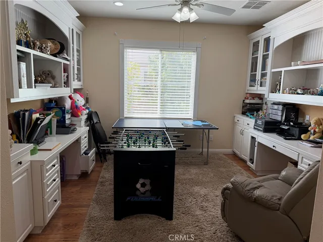 a bedroom with a bed and a mirror on the dresser